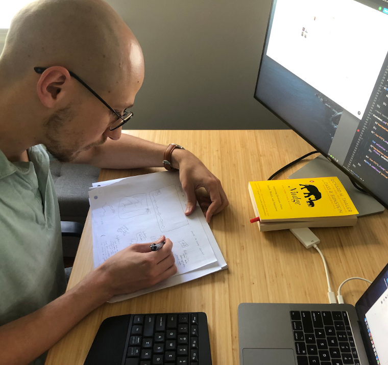 Derek working at his desk
